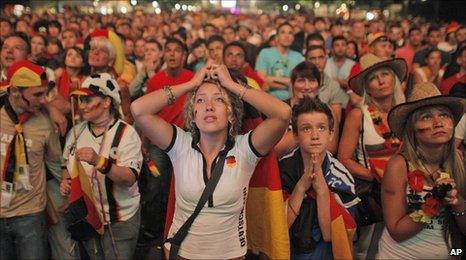 German football fans in Berlin react as they watch the Germany-Spain semi-final