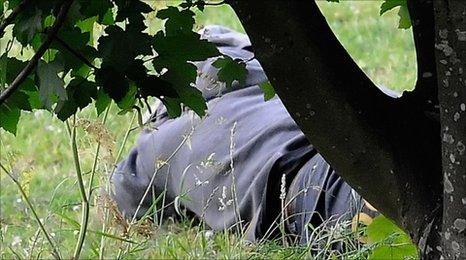 A man fitting the description of Raoul Moat lying on the ground in Rothbury, Northumberland