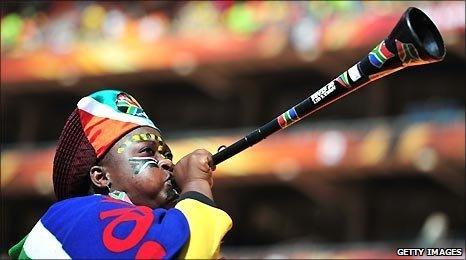 A South African fan blows a vuvuzela