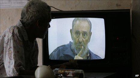 Cuban man watches Castro on TV