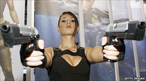 An actress dressed-up as Lara Croft from Tomb Raider poses for a photo