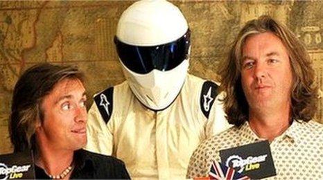 The Stig with Top Gear co-stars Richard Hammond and James May