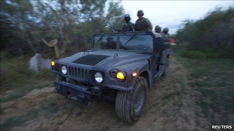 Mexican soldiers patrol a road after a gunfight with drug gang members near Monterrey. Photo: 2 September 2010