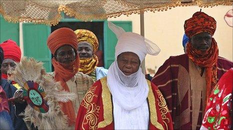 The emir of Zazzau, a traditional ruler, with courtiers and advisors arriving for a ceremony