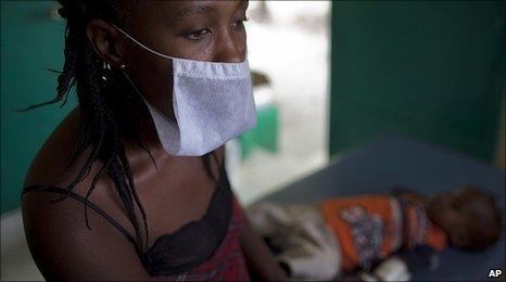 Woman waits with her son who has cholera symptoms