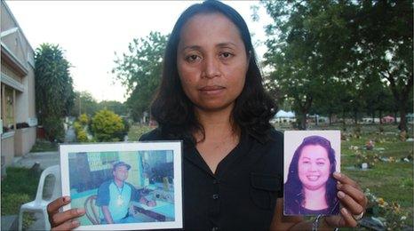 Grace Morales holding pictures of her husband and sister who were killed in the Maguindanao massacre, picture taken November 2010