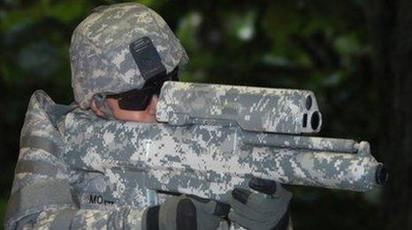 A US soldier holds the XM-25