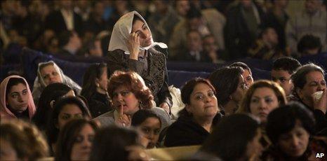 Christian women attend the Christmas Eve Mass at the Coptic cathedral in Cairo