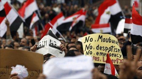Protesters wave flags as they chant anti-government slogans during demonstrations against Egypt's president in Alexandria