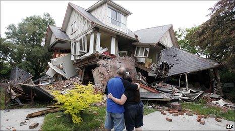 Christchurch residents Murray and Kelly James look at their destroyed house on 23 February 2011