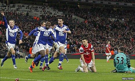 Martins and Birmingham celebrate after an Arsenal mix-up