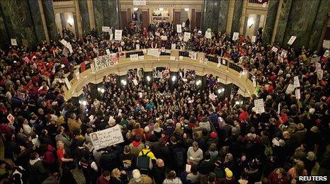 Protesters take over the Wisconsin state capitol in Madison after the vote