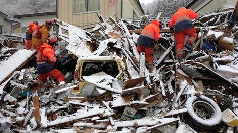 Rescue workers searching debris in Japan