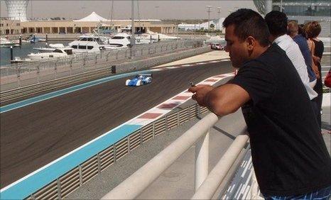 Samit Patel watches the race cars in Abu Dhabi