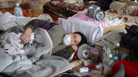 A woman catches up on sleep at a centre in Yamada, Iwate prefecture