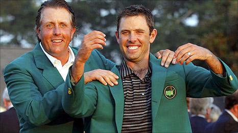 Charl Schwartzel receives his Green Jacket from 2010 champion Phil Mickelson