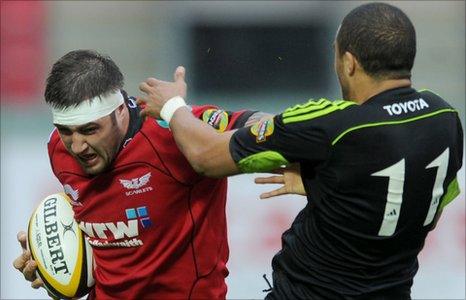 Scarlets back-row Josh Turnbull is tackled by Munster try-scorer Simon Zebo