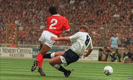 Paul Gascoigne (r) fouls Gary Charles