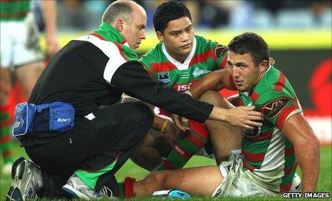 Sam Burgess is tended to after injuring his ankle