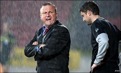Billy Reid is caught in the McDiarmid Park downpour