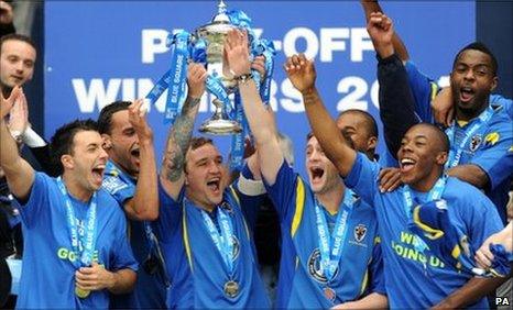 AFC Wimbledon's Danny Kedwell lifts the trophy