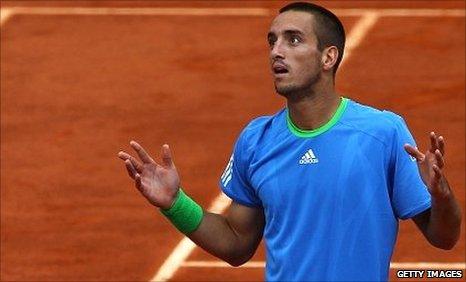 Viktor Troicki gestures to the umpire after the ball boy incident