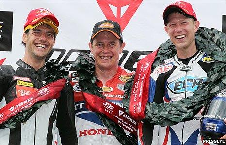 Winner John McGuinness is flanked on the podium by runner-up Cameron Donald and Gary Johnson who finished third