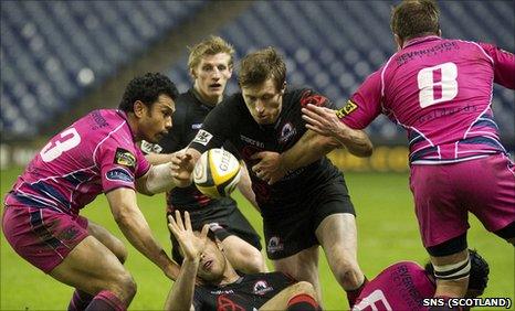 Edinburgh's Jim Thompson (centre) is closed down by Cardiff duo Casey Laulala and Xavier Rush (right)
