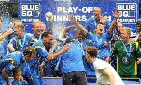 AFC Wimbledon celebrate sealing their place in the Football League