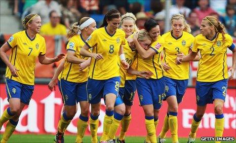 Marie Hammarstrom (number 20, partially hidden) is congratulated after scoring the winning goal