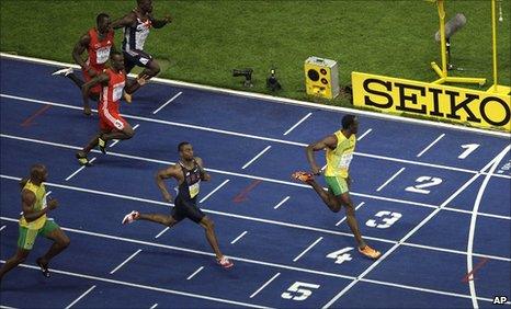 Asafa Powell (left) trails Usain Bolt (right)