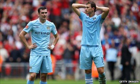 Manchester City players Adam Johnson and Edin Dzeko