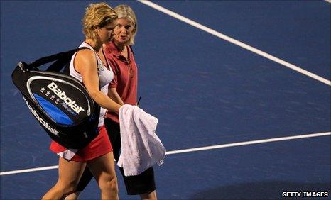 Kim Clijsters leaves the court with a WTA physio