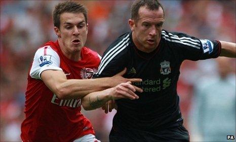 Arsenal's Aaron Ramsey and Liverpool's Charlie Adam battle for the ball