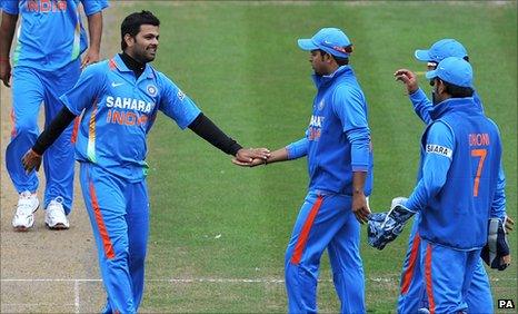 RP Singh (left) is congratulated after taking one of his four wickets