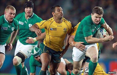 Kurtley Beale of Australia tackles Ireland captain Brian O'Driscoll