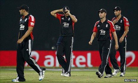 Alastair Cook (centre) trudges off with his team-mates in Delhi