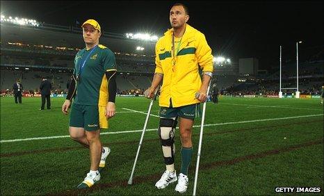 Quade Cooper leaves the stadium on crutches with his knee in a brace