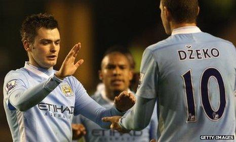 Adam Johnson (left) of Manchester City celebrates scoring his sides first goal with Edin Dzeko