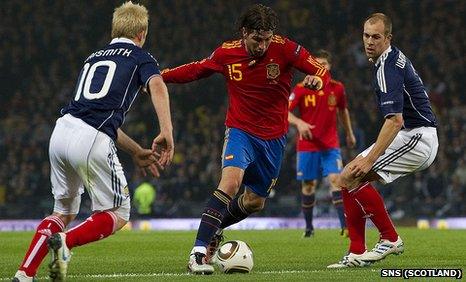 Spain defender Sergio Ramos causes problems for Steven Naismith (left) and Steven Whittaker (right)