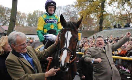 Kauto Star enters the winners enclosure with rider Ruby Walsh, owner Clive Smith (left) and trainer Paul Nicholls (right) after winning the Betfair Chase