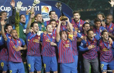 Carles Puyol (centre) lifts the trophy