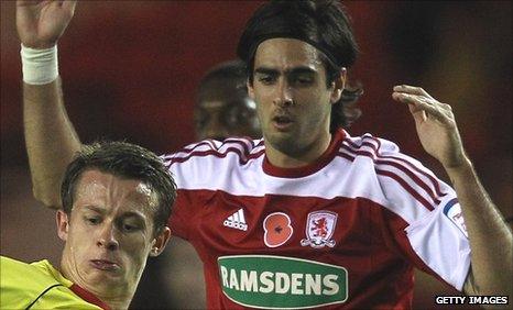 Rhys Williams tussles with a Watford player