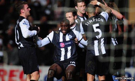 Newcastle striker Demba Ba (centre) celebrates with his team-mates