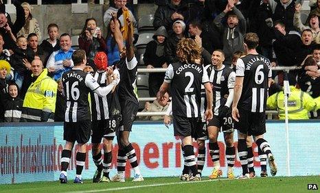 Jonas Gutierrez (centre) celebrates in a Spiderman mask