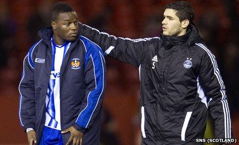 William Gros (left) is consoled by Aberdeen striker Mohamed Chalali