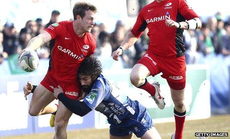 Saracens wing James Short pass the ball out of a tackle by Ludovico Nitoglia