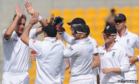 England celebrate a wicket by Stuart Broad (far left)