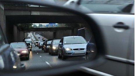 Reflection of traffic in a car wing mirror