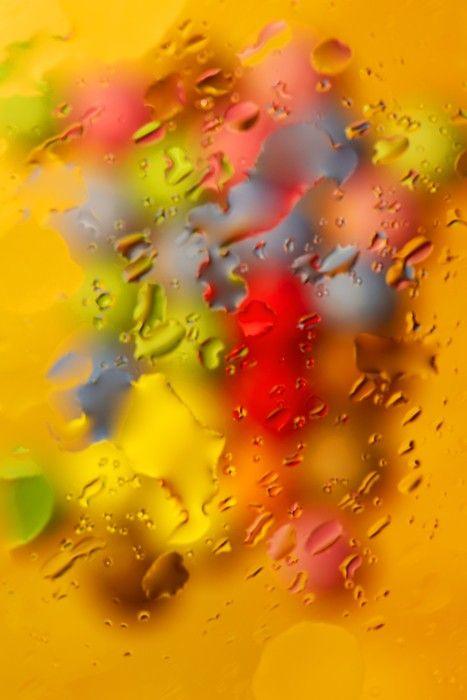 Smarties photographed through glass with water smeared across the surface
